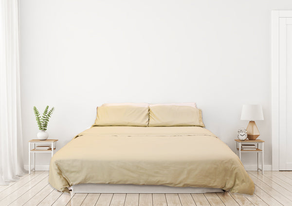 gold comforter cover on the bed